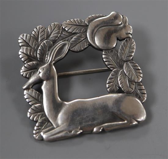 A Georg Jensen sterling kneeling deer with squirrel square brooch, no. 318, 38mm.